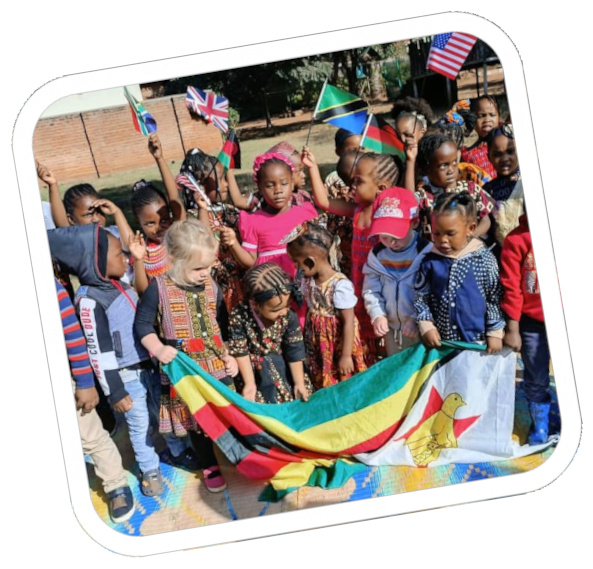 kids posing for phot holding national flags